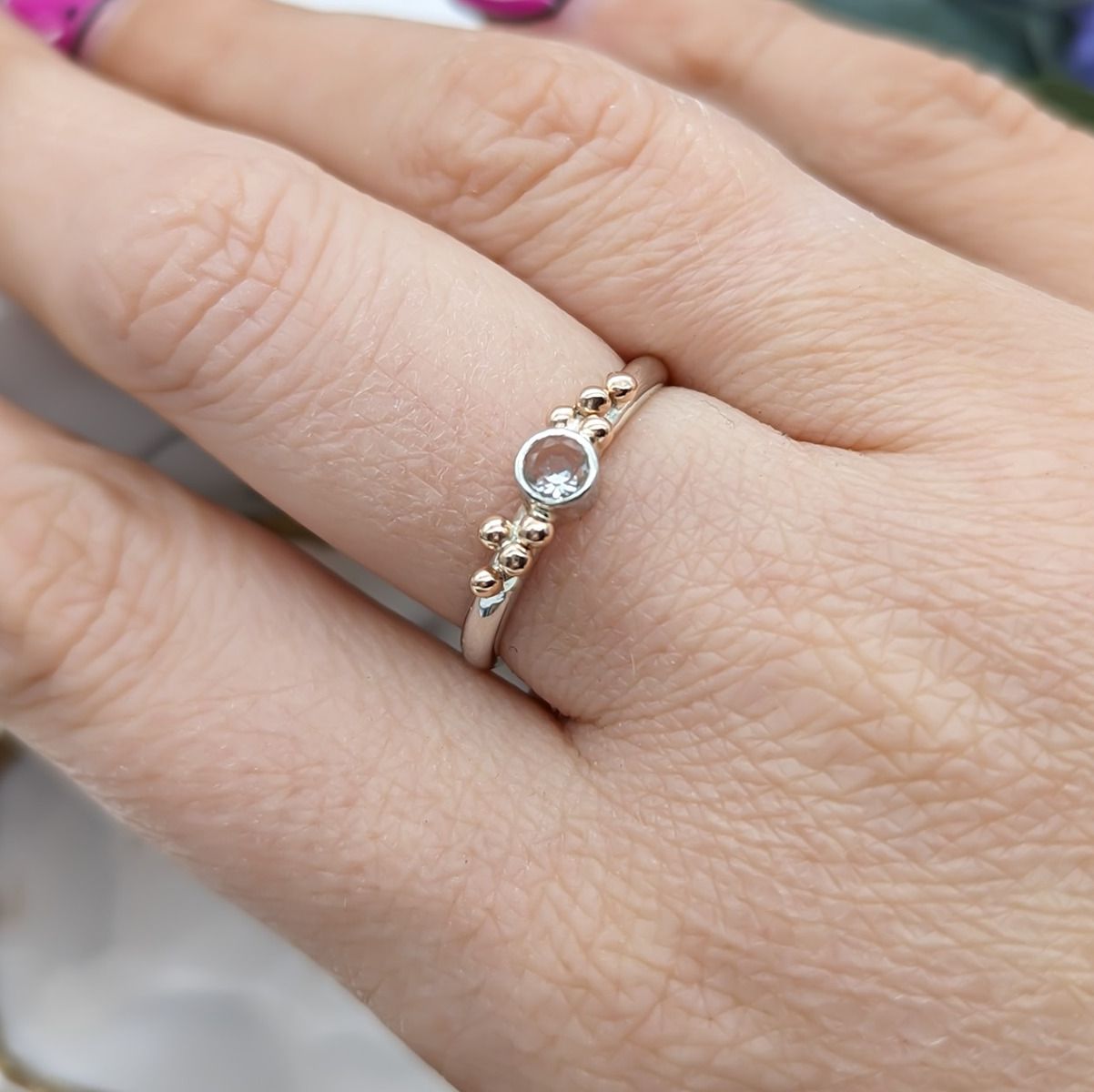 White Topaz and Rose gold granulation ring modelled on a hand