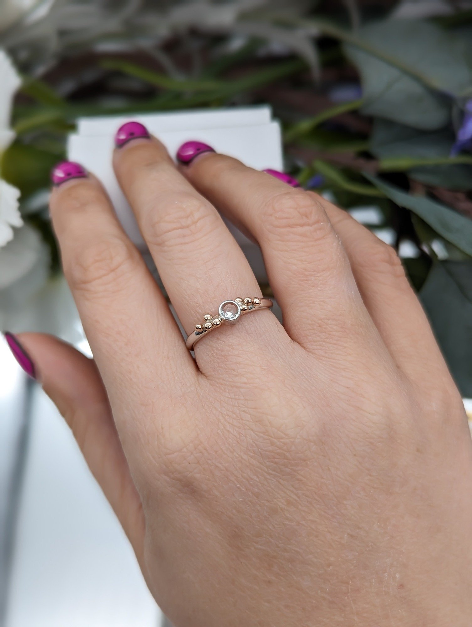 White Topaz and Rose gold granulation ring modelled on a hand