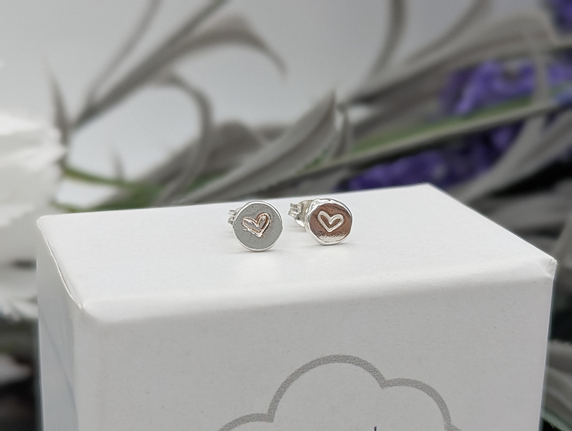 heart  stamped silver studs on a jewellery box
