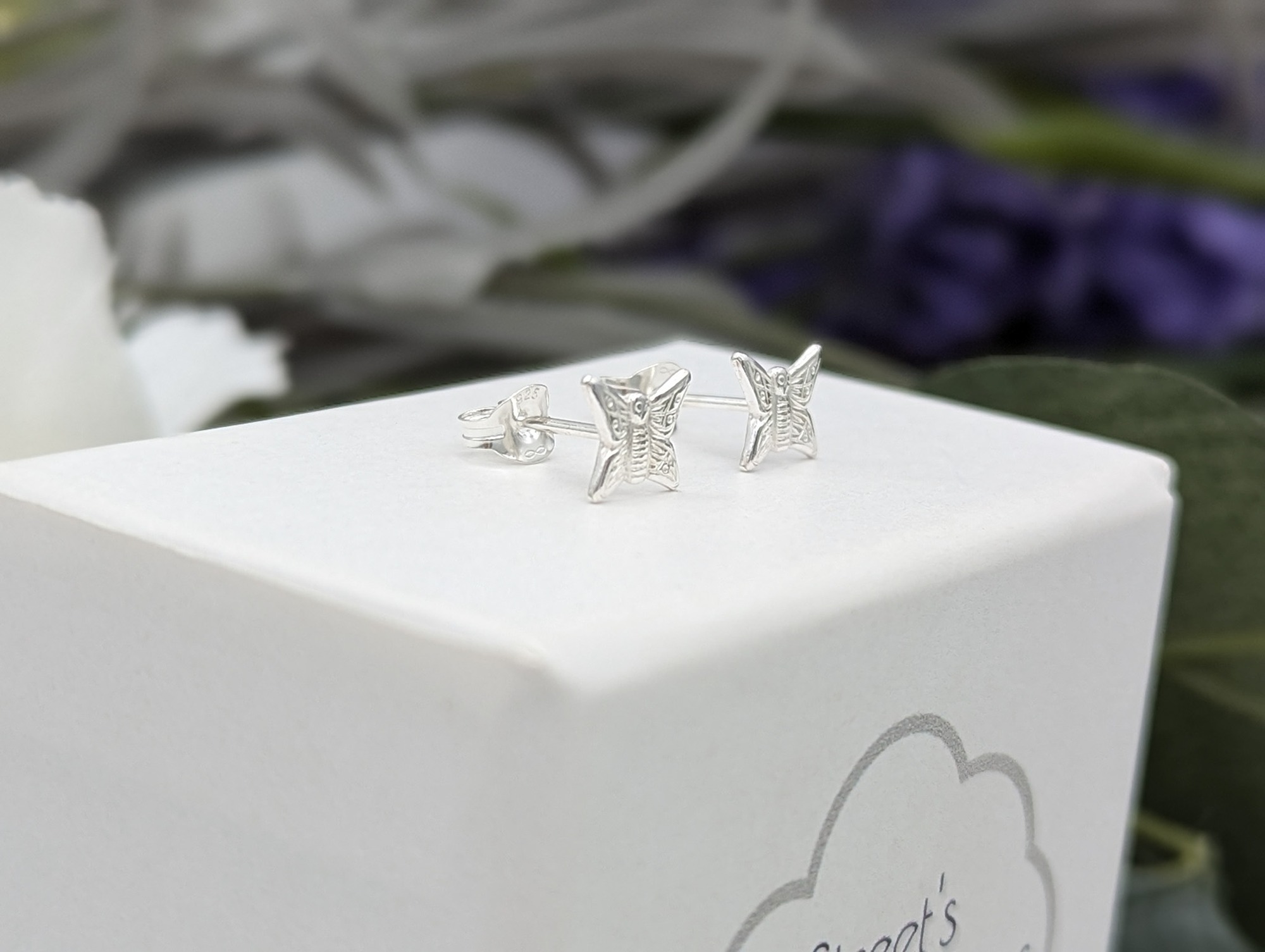 side profile of silver butterfly earrings