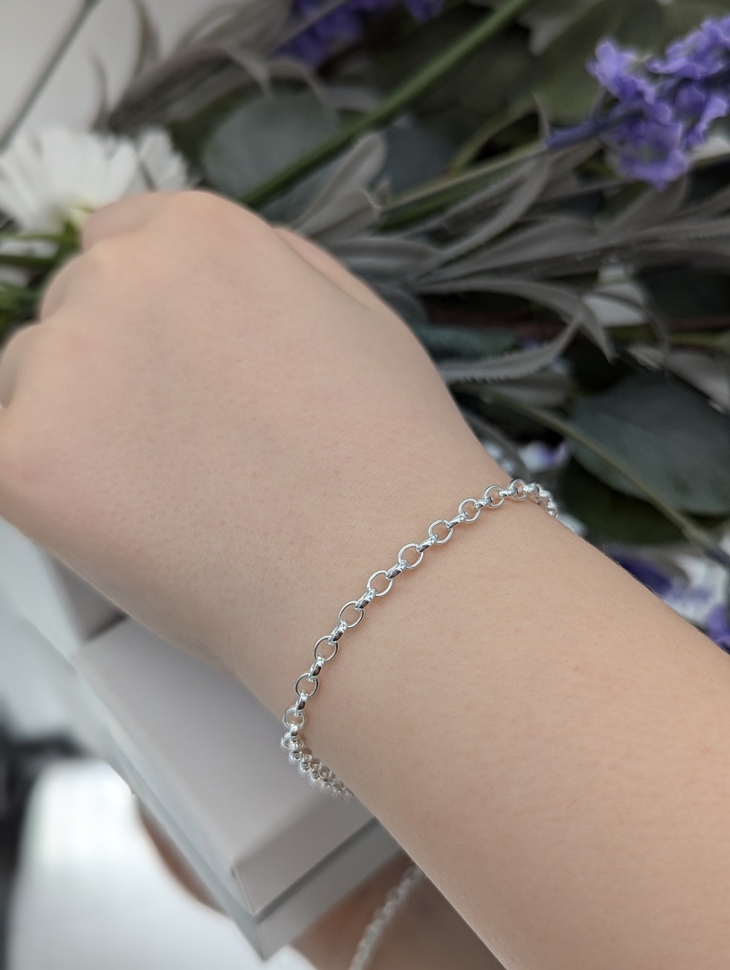 Oval belcher silver bracelet being worn on wrist 