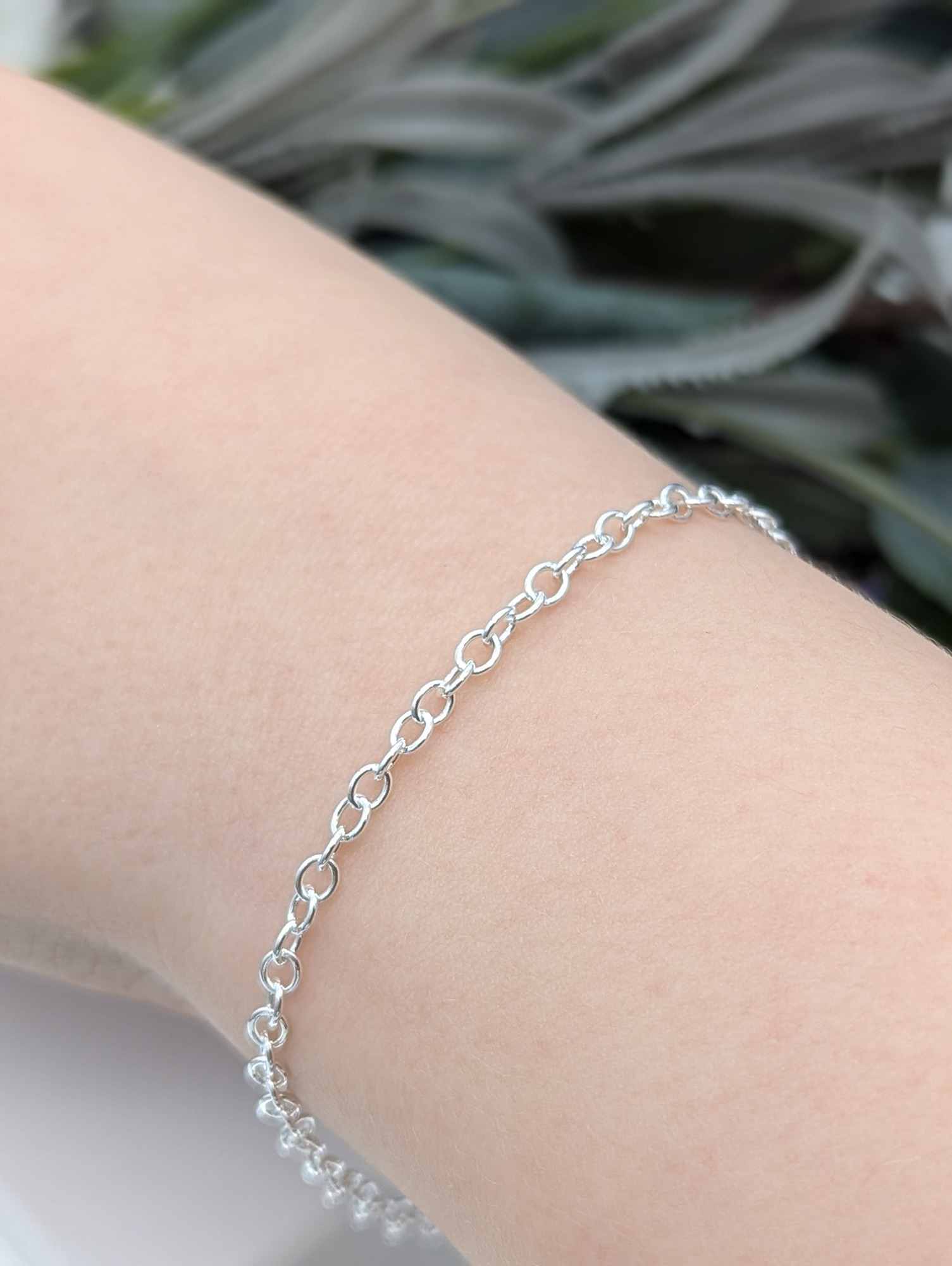 silver trace chain bracelet being worn on a wrist