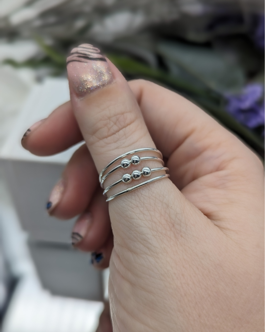 Silver fidget ring being modelled as a thumb ring