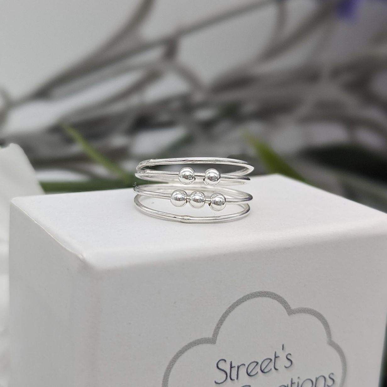 Fidget ring resting white jewellery box