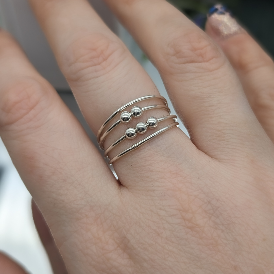 silver fidget ring being worn on a hand
