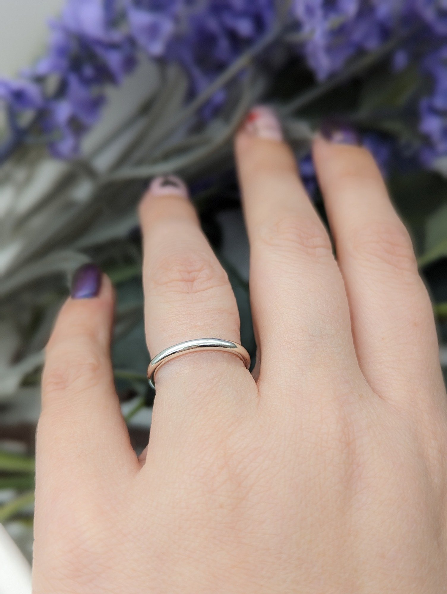 Silver shape ring worn on the ring finger