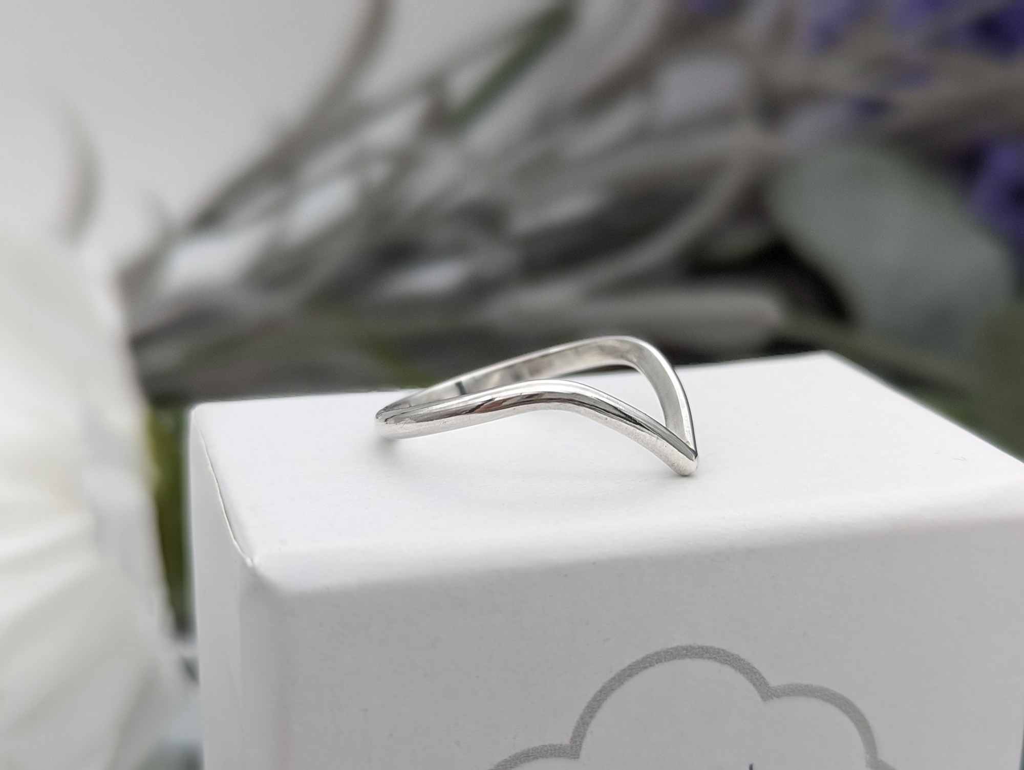 side profile of a silver wishbone ring