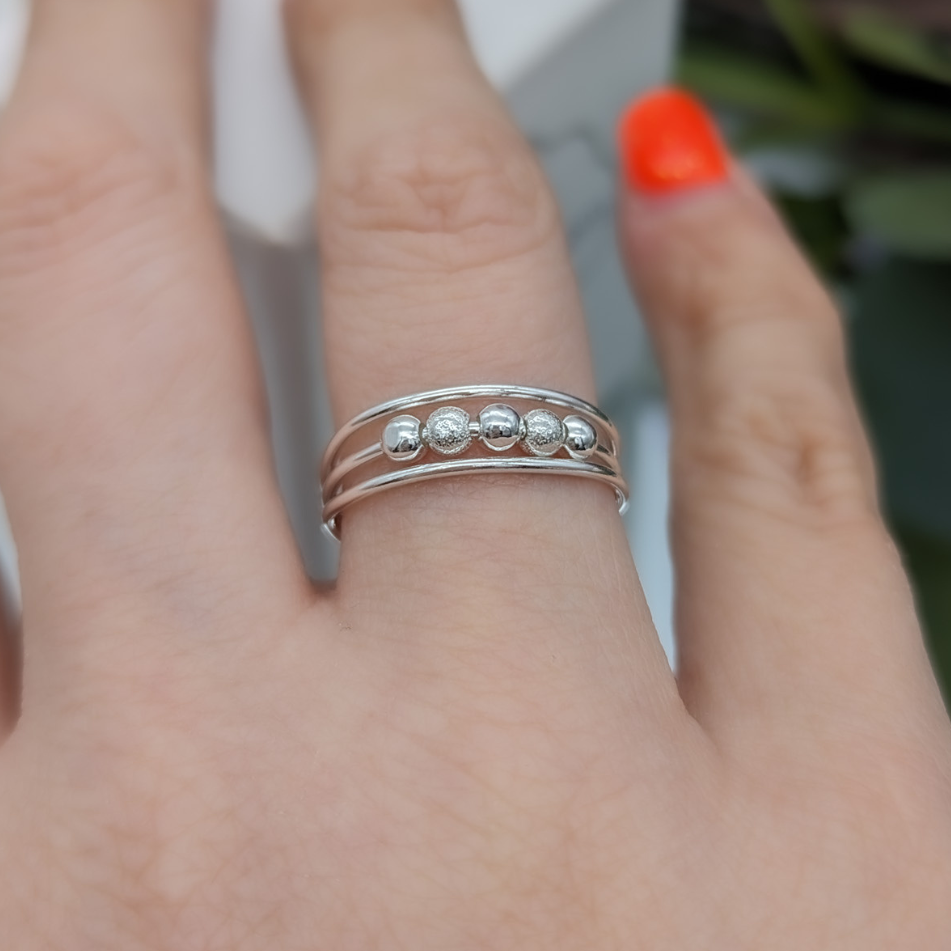 silver fidget ring being worn on a hand