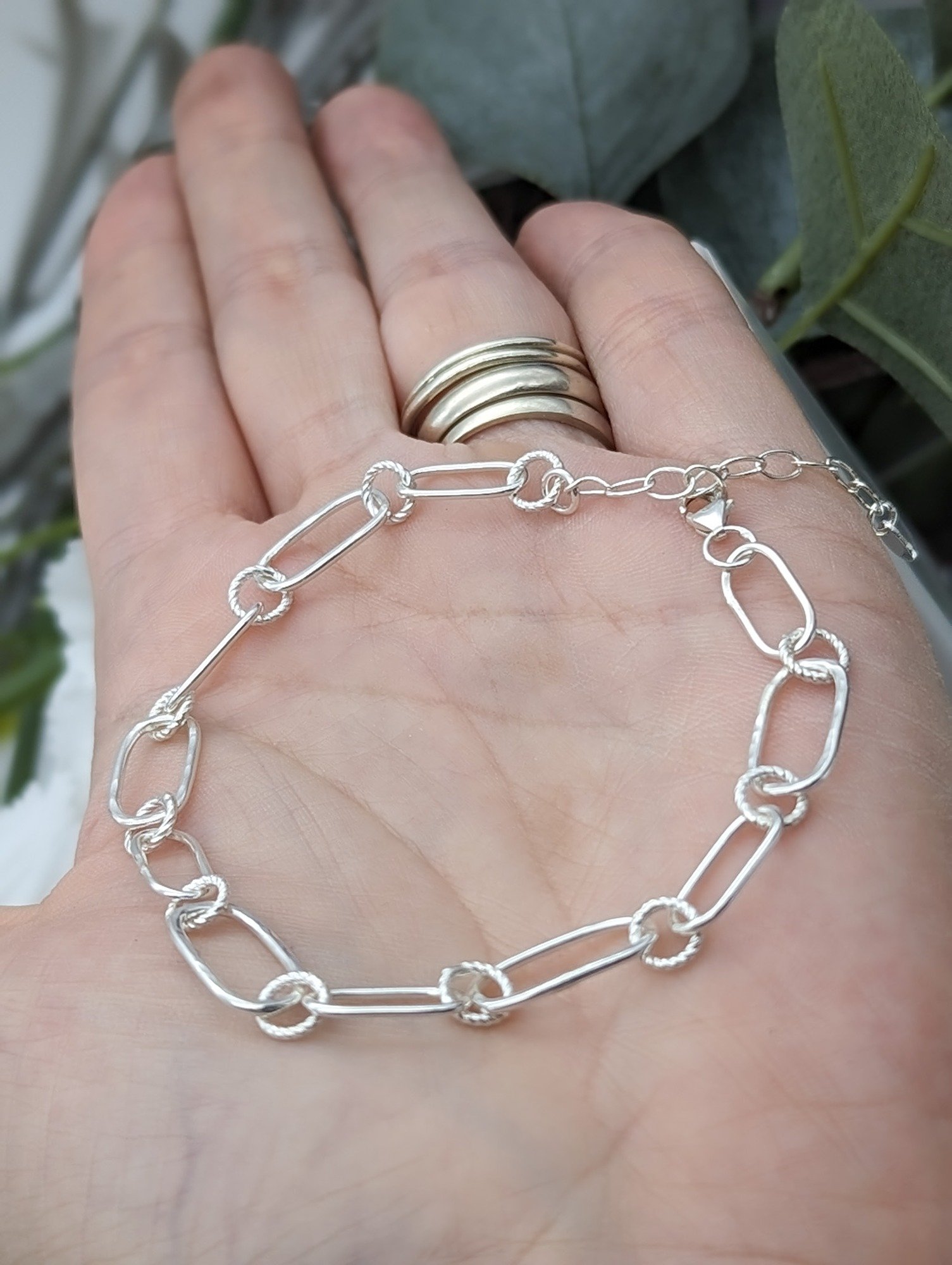 Textured link bracelet held in a hand