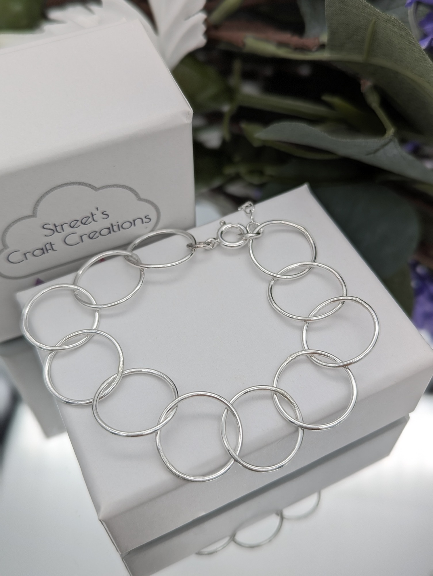 Circle link bracelet on a white jewellery box