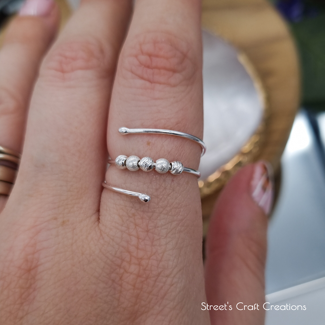 Silver fidget wrap ring on a finger