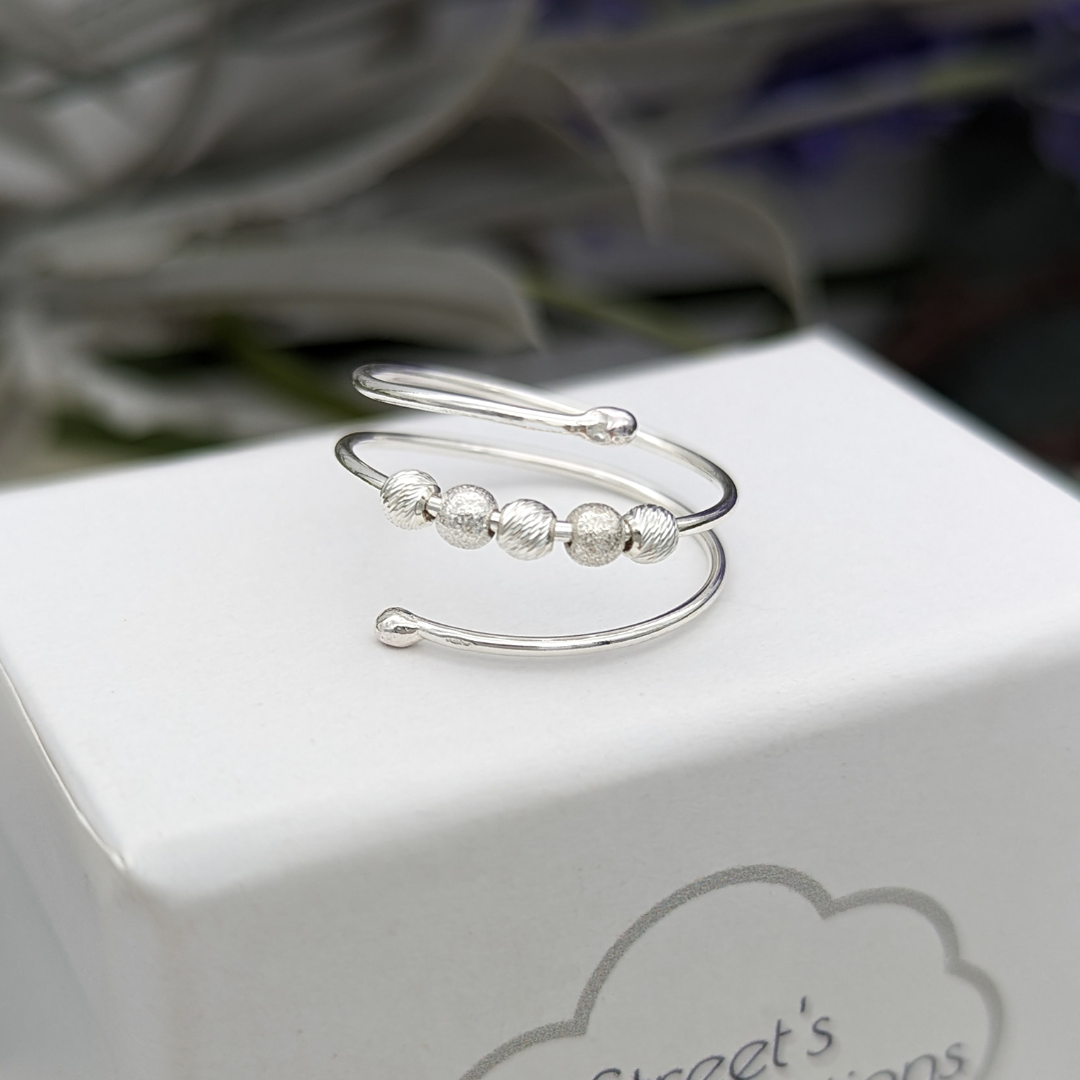 Silver wrap ring on a white jewellery box