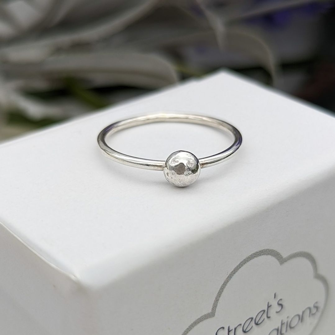 Pebble silver ring on a white jewellery box