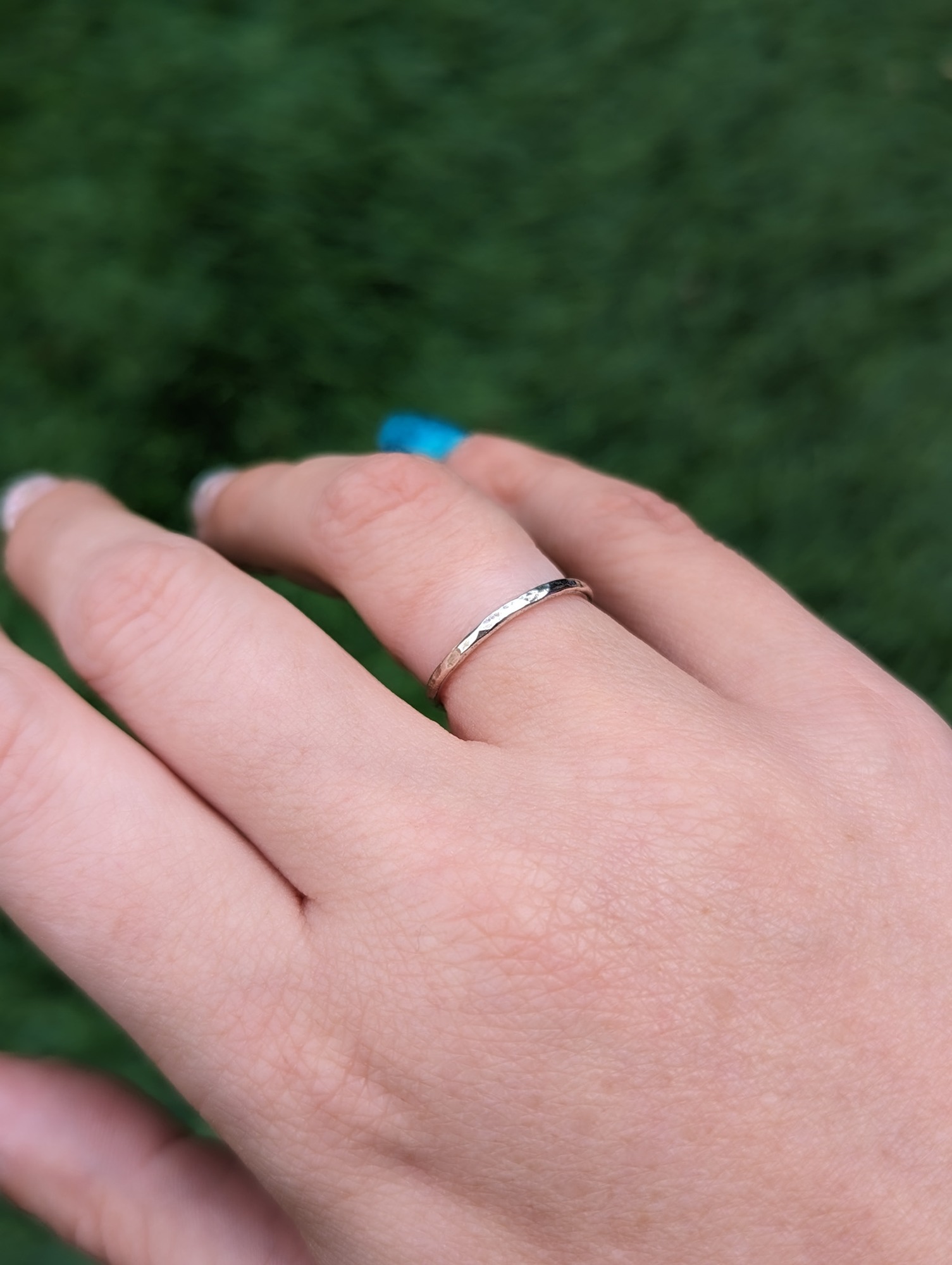 Hammered stacking ring worn on a finger