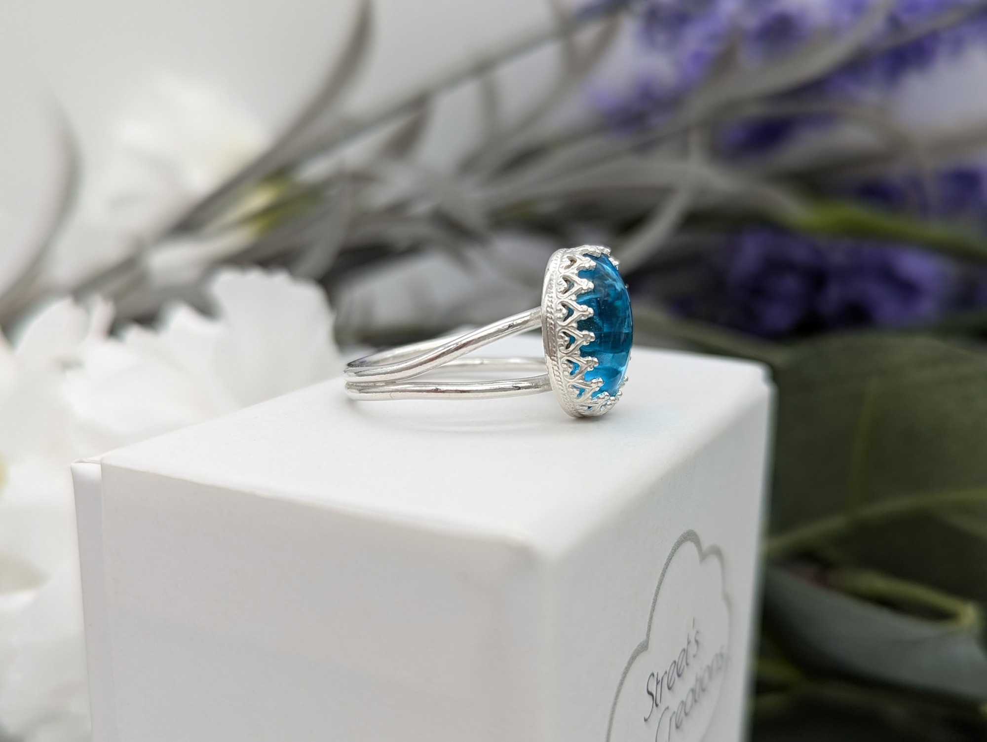 Side profile of a silver & aqua glass cabochon ring