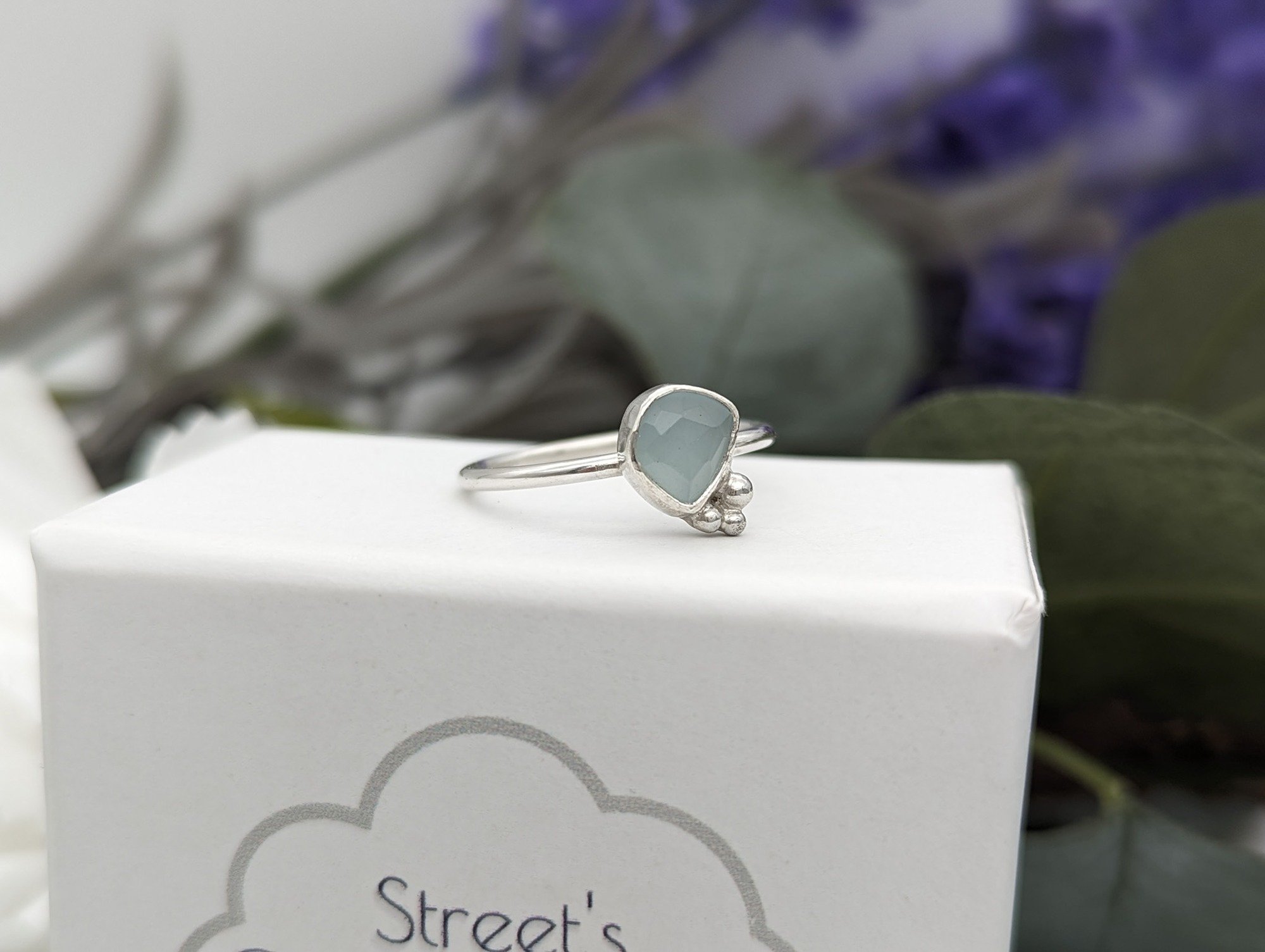 Silver Aquamarine resting on a white jewellery box