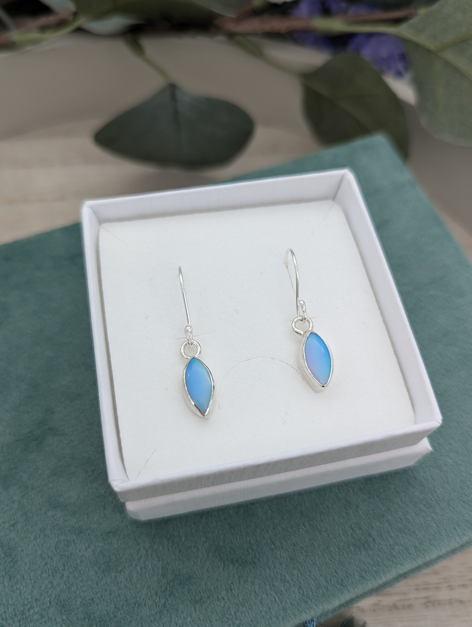 Baby blue aurora opal earrings in a jewellery box
