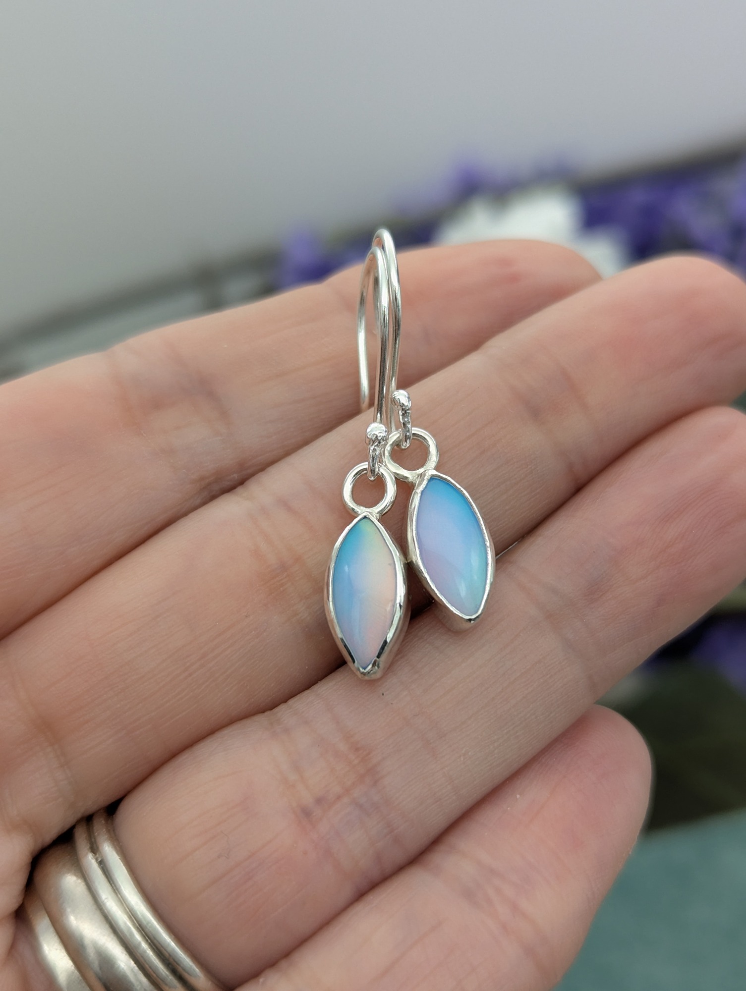 Silver Aurora opal earrings showing the purple flash