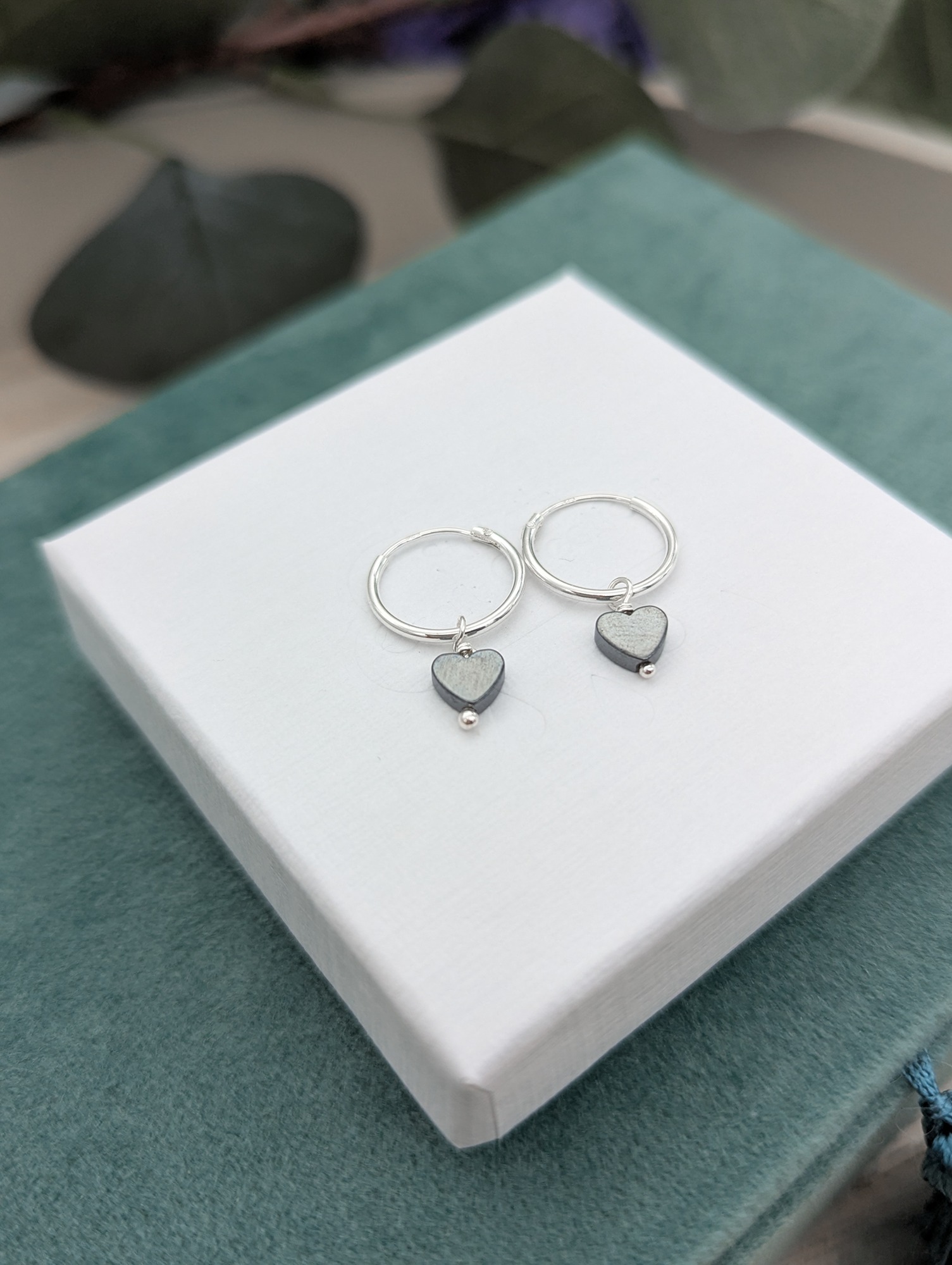 Hematite heart gemstones on silver hoop earrings