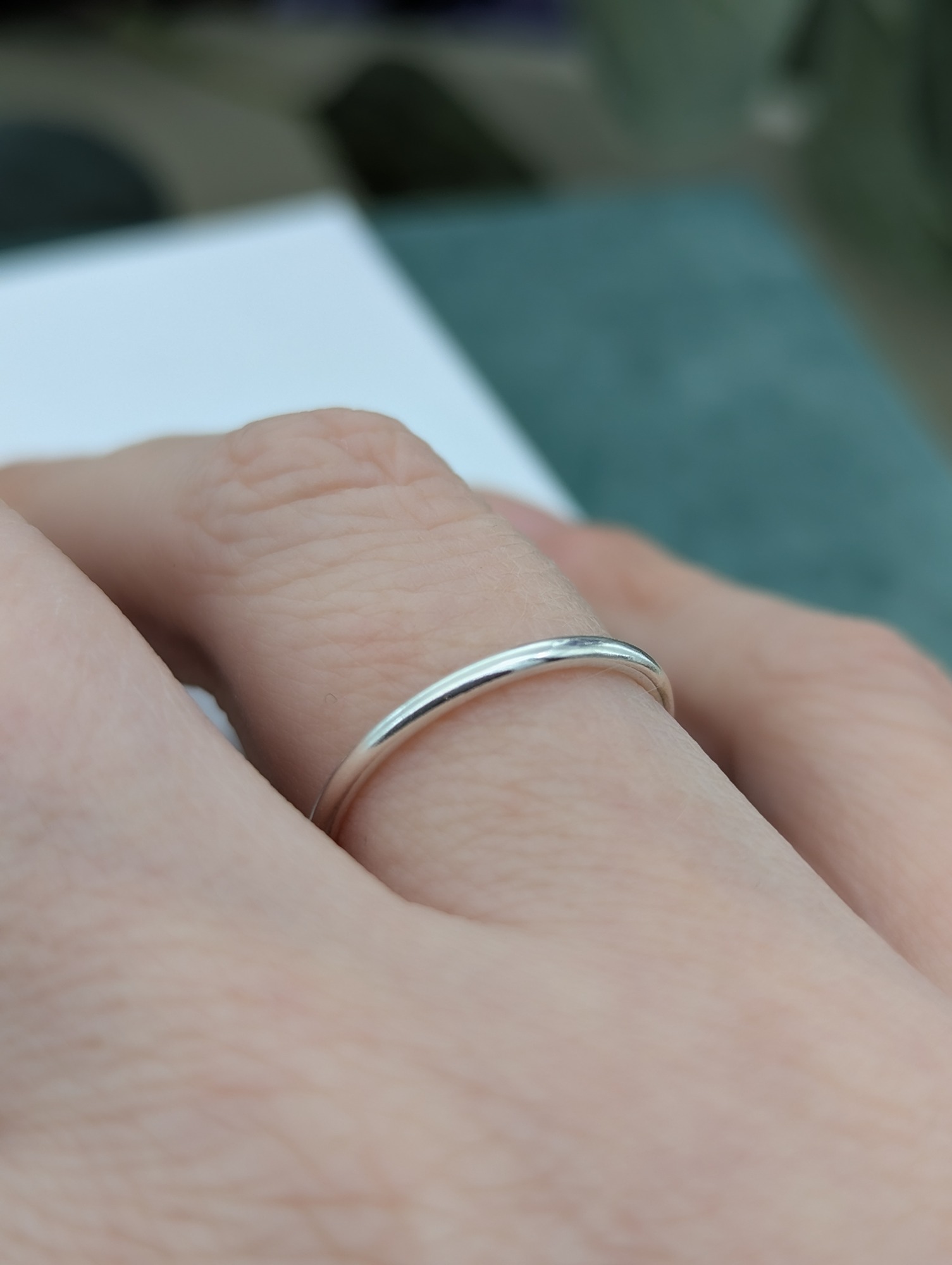 Silver stacking ring modelled on a finger