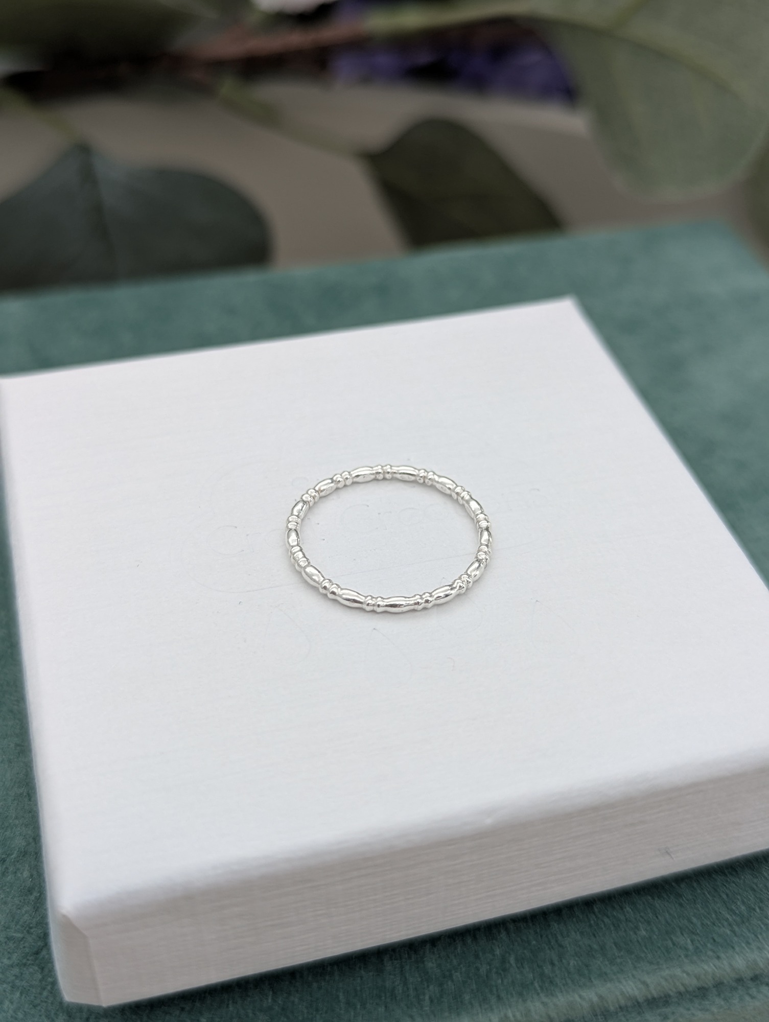 Decorative Silver stacking ring modelled on a finger