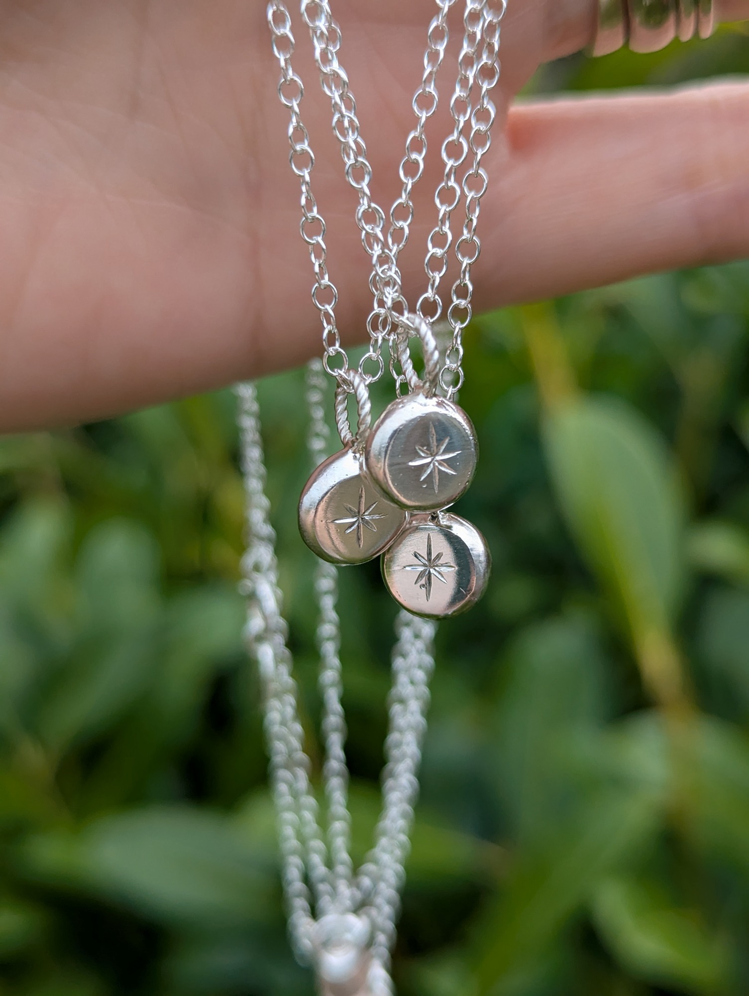 3 North star necklaces hanging together