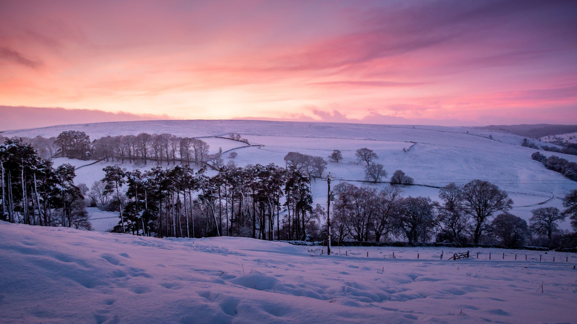 The sun sets over wheeledale and creates a stunning purple haze over the whole scene. The landscape is covered in deep snow