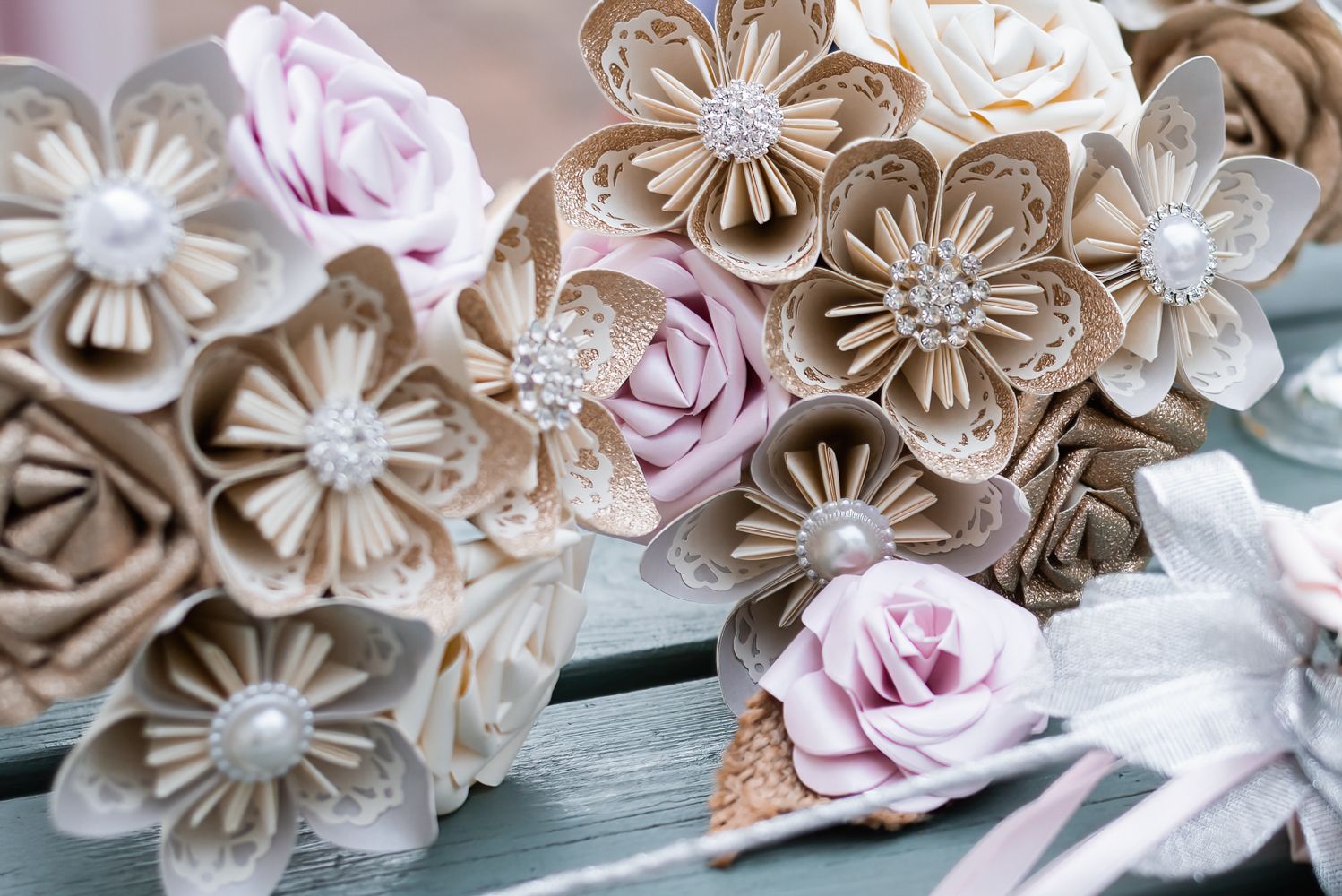 The bouquets are made of paper flowers and feature cream, brown and pink handmade flowers