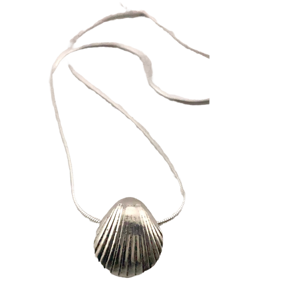 A solid silver shell pendant, made by creating a mould of a real shell foun