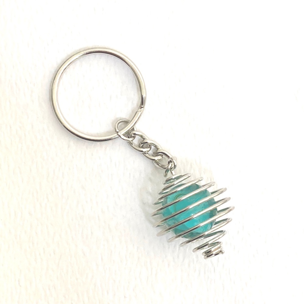 Turquoise/Blue vintage glass marble in silver cage on a key chain