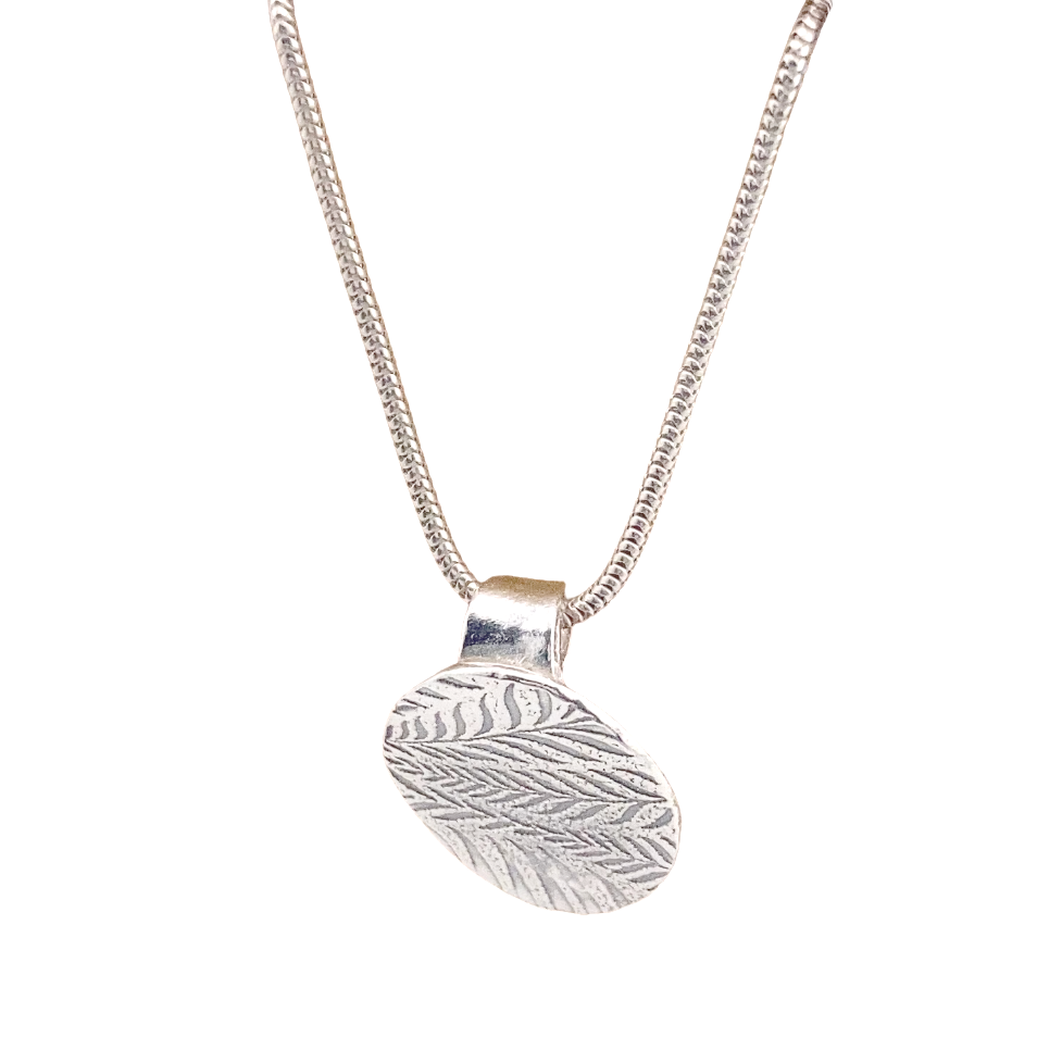Handmade silver oval pendant with fern leaf textures