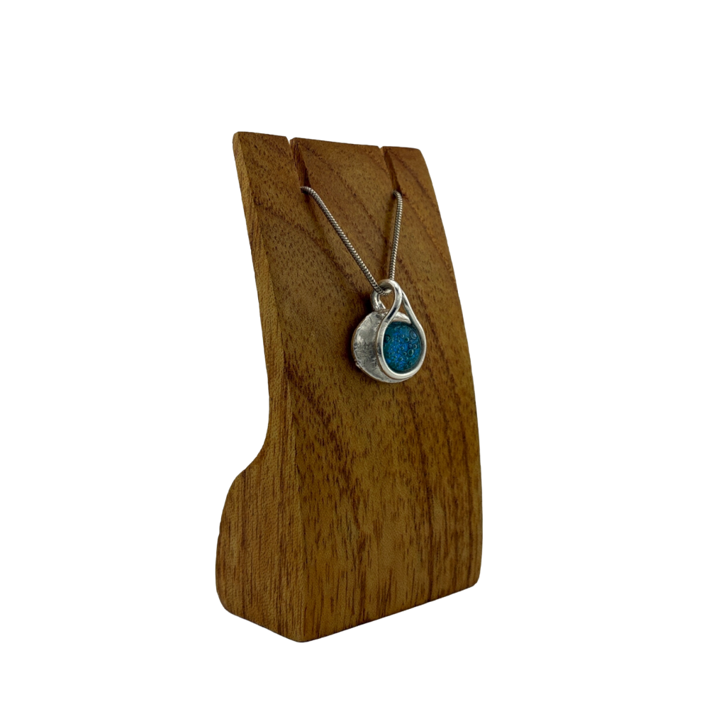 Oval turquoise blue glass dragon's eye pendant with a wrap around 'snake' of silver bail