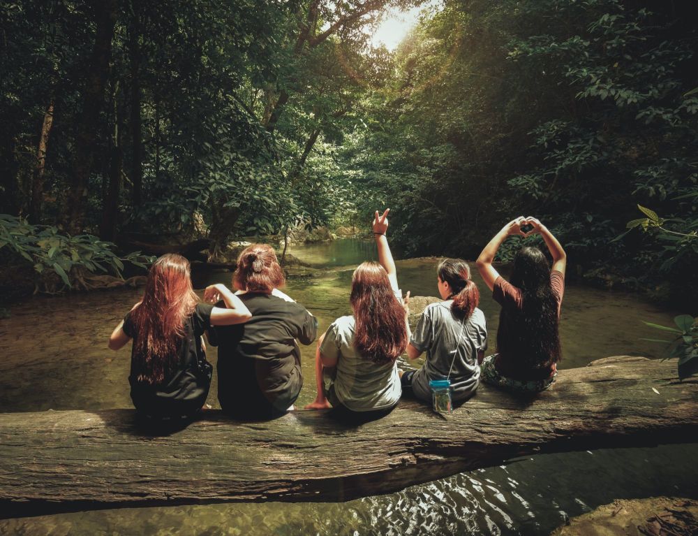 five-women-sitting-on-tree-trunk-1360255