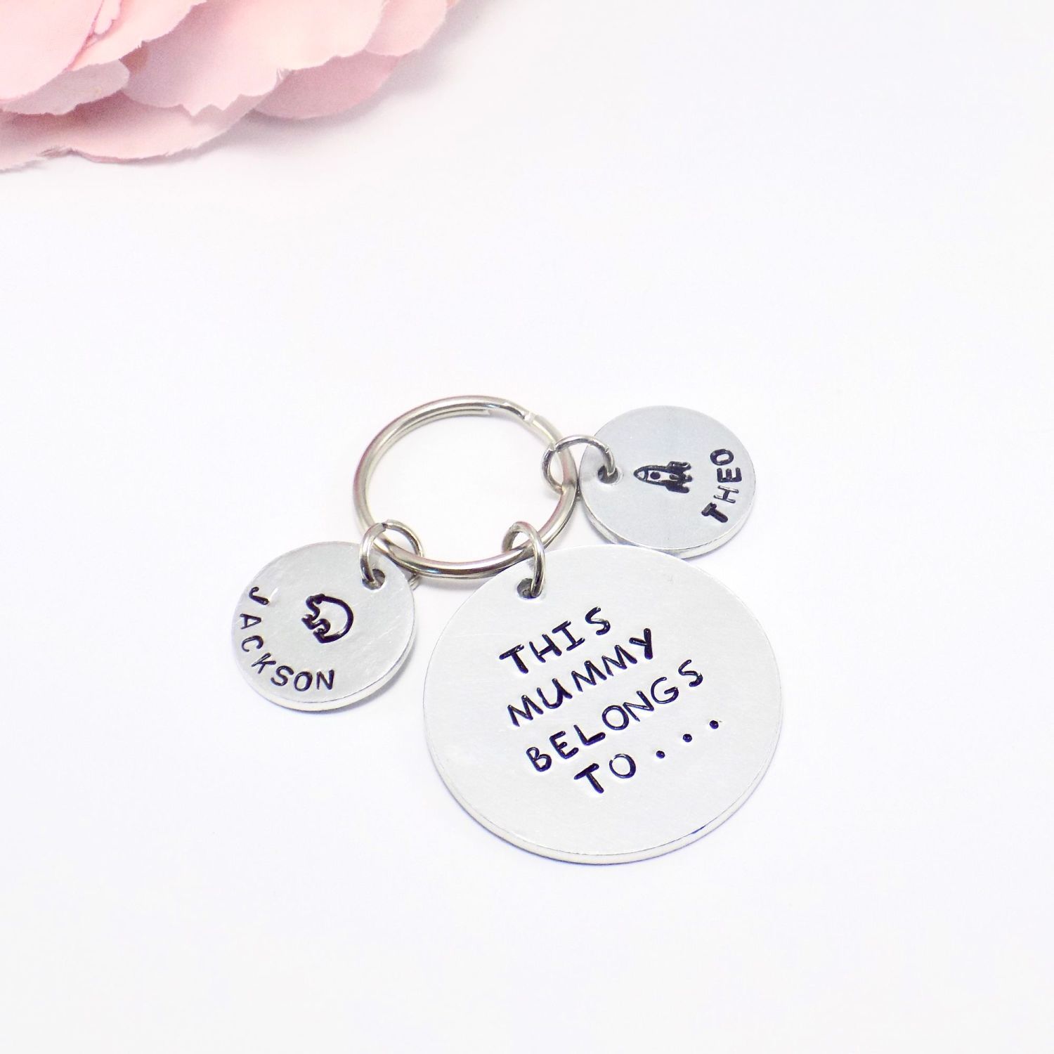 Tokens on a keychain stamped with childrens names and symbols