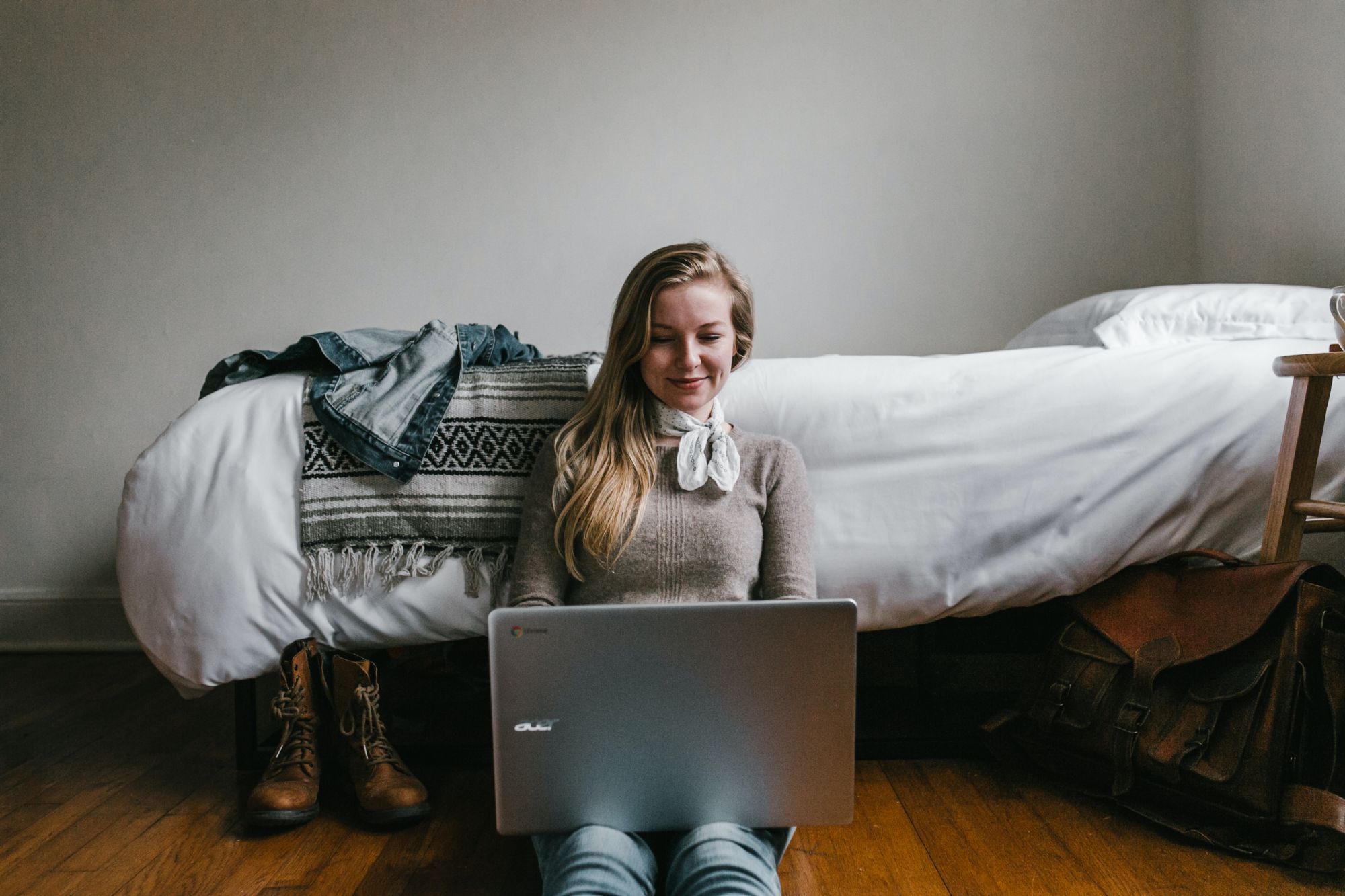 Person at their bedside browsing on their laptop