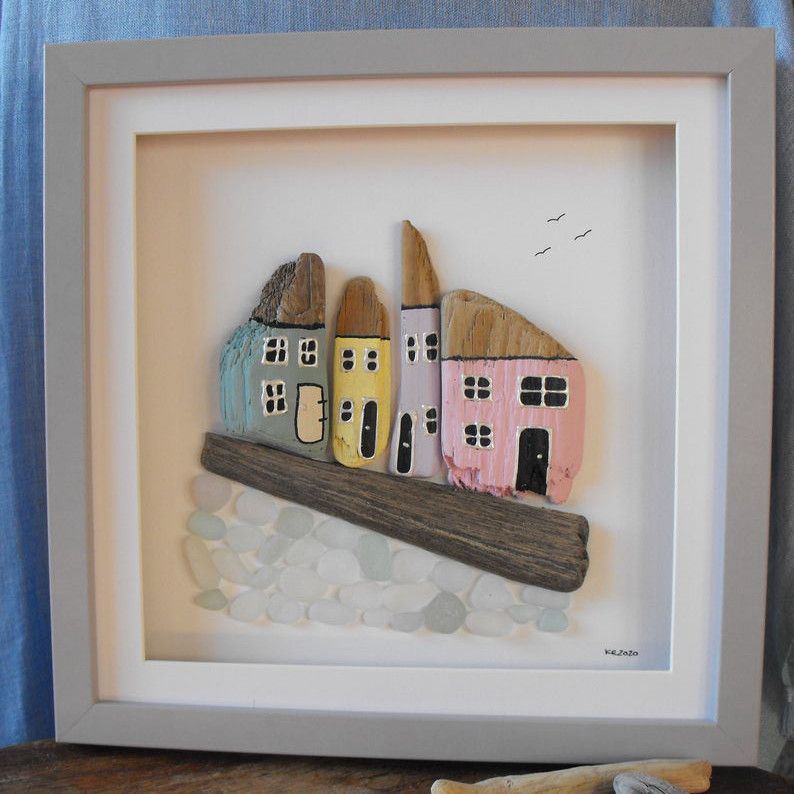 Frame art of cottages made from driftwood and sea glass