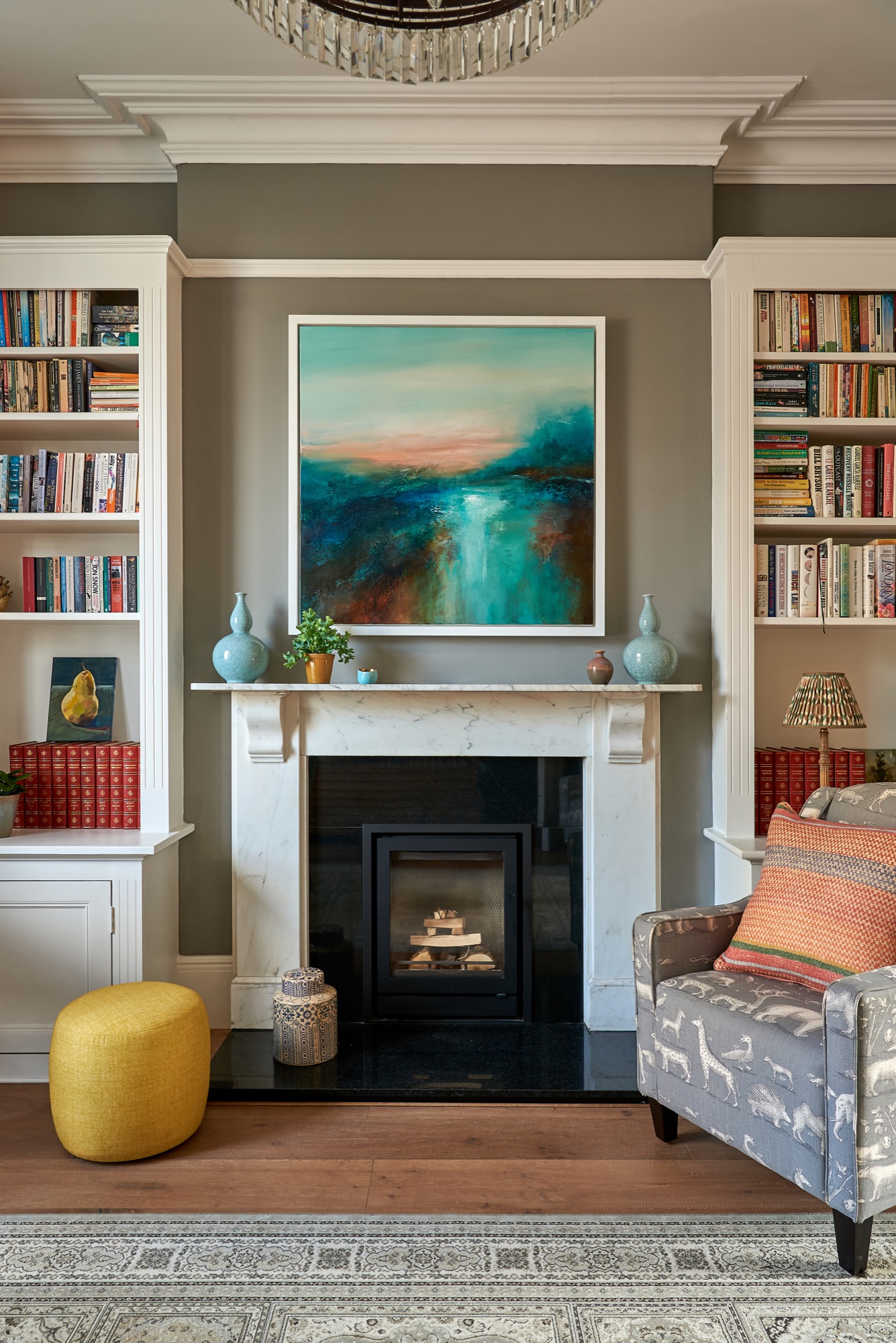 Beautiful Georgian town house painted in worsted farrow and ball, with styled book shelves and  Andrew Martin upholstered armchairs and cushions.