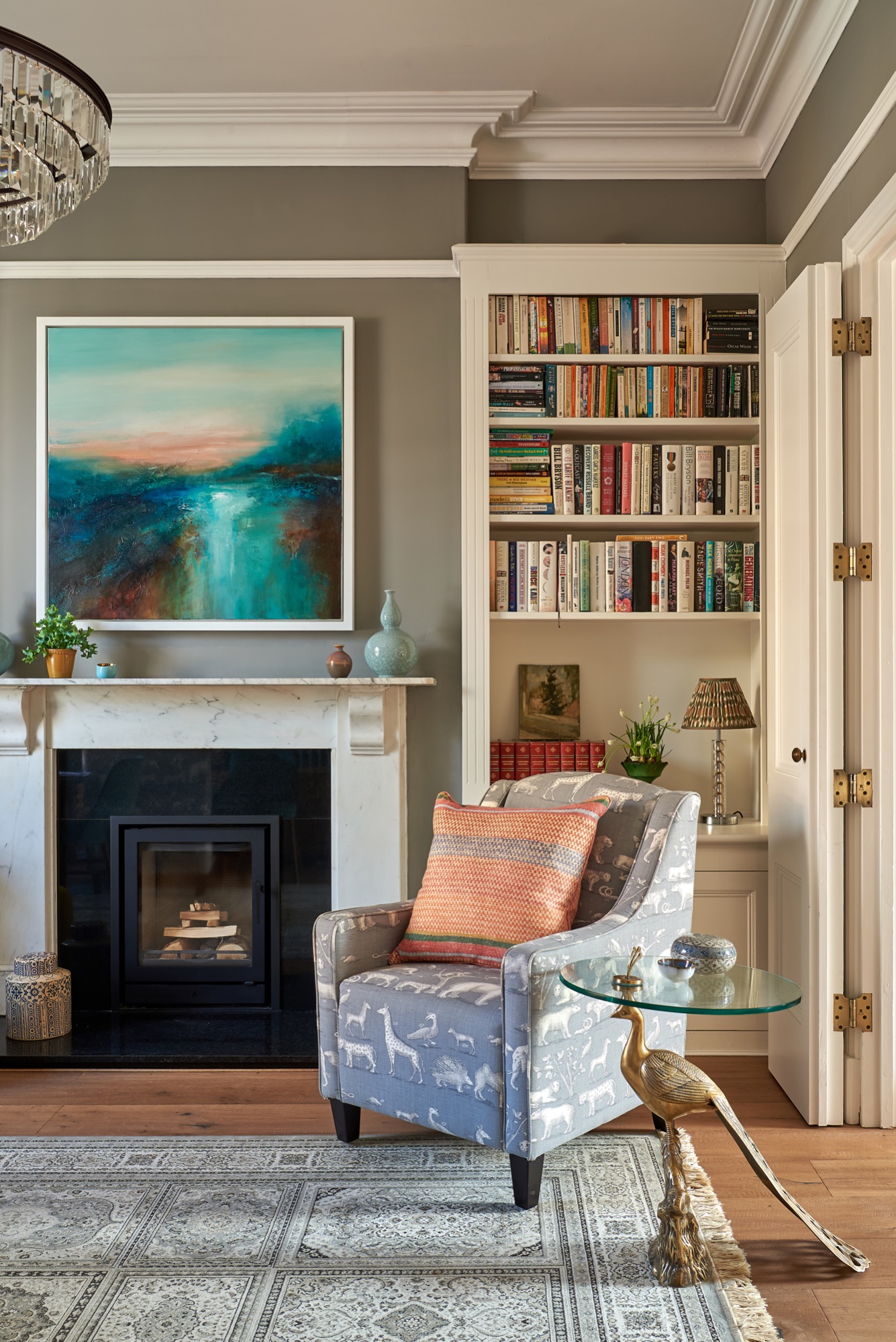 Beautiful Georgian town house painted in worsted farrow and ball, with styled book shelves and  Andrew Martin upholstered armchairs and cushions. 