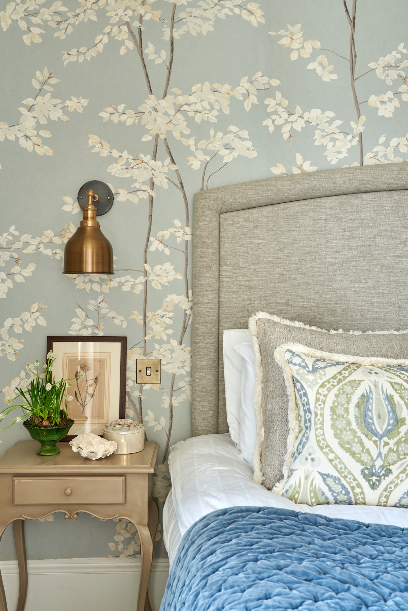Beautiful calming master bedroom wallpapered in Lewis and wood Beech wallpaper and industville wall lights. Lewis and wood Benaki and Andrew Martin cushions and a velvet blue Oka throw