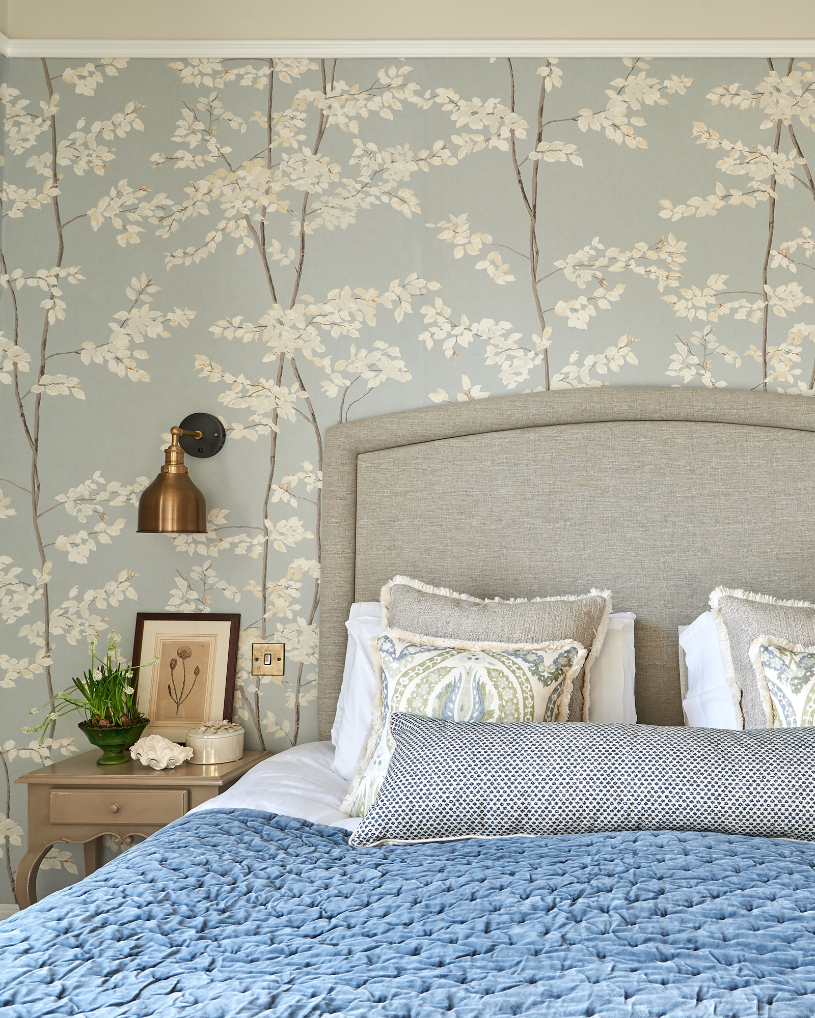 Beautiful calming master bedroom wallpapered in Lewis and wood Beech wallpaper and industville wall lights.. Lewis and wood Benaki and Andrew Martin cushions and a velvet blue Oka throw