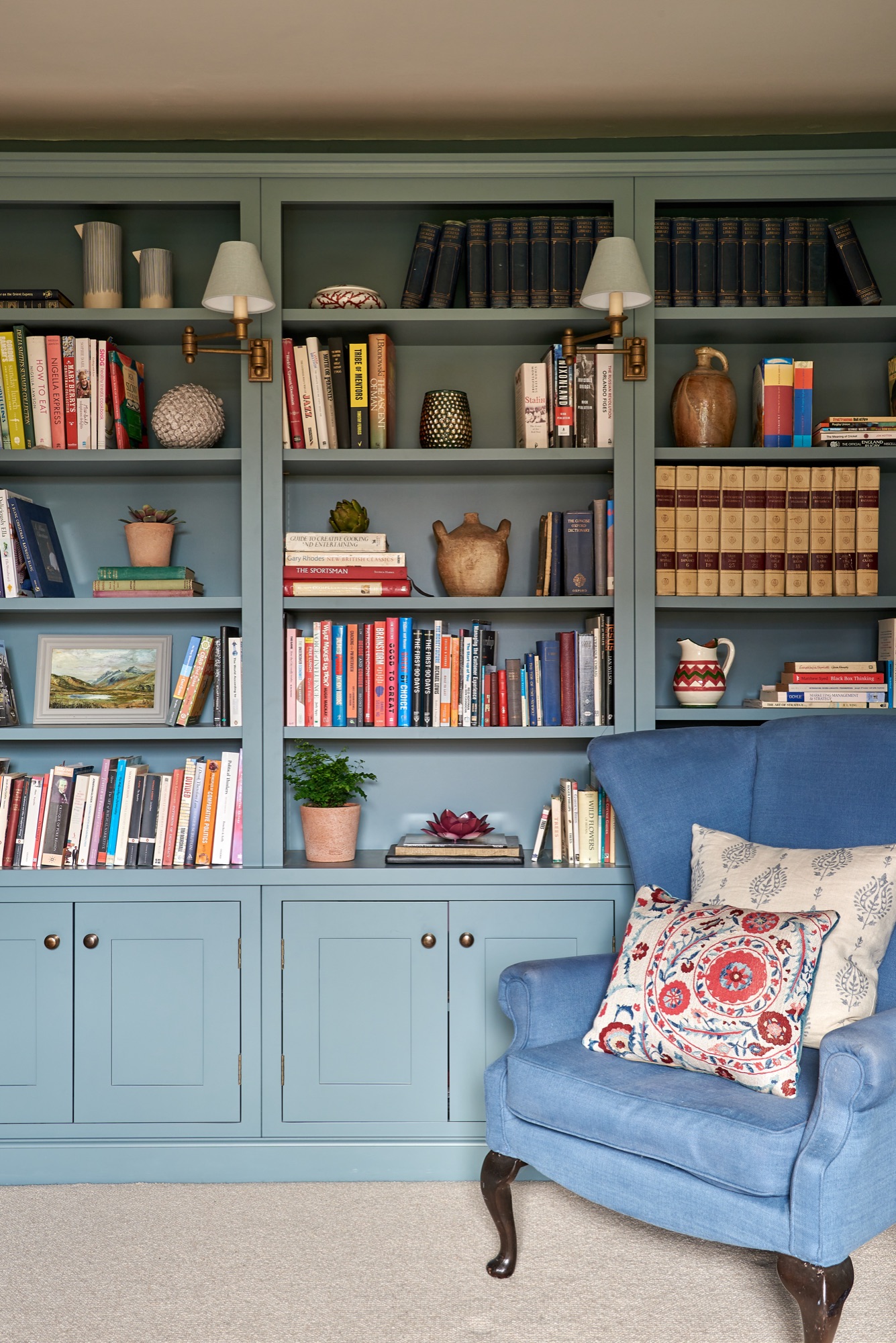 stylish study are with kealers cabinetry with farrow and ball paint.  sander sons cushions on a wingback chair.