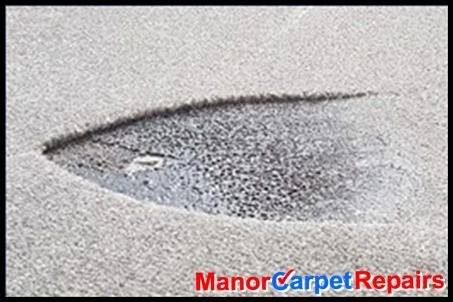 Iron burn carpet damage. Manor Carpet Care can repair this.