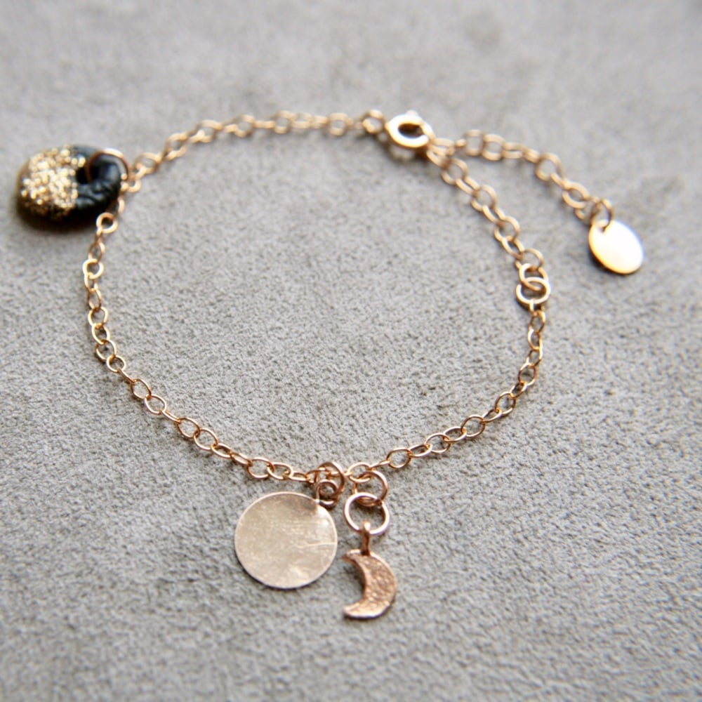 Gold bracelet with smooth discs, moon and star