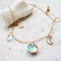 14k gold charm bracelet with handmade porcelain seashell and gold moons.