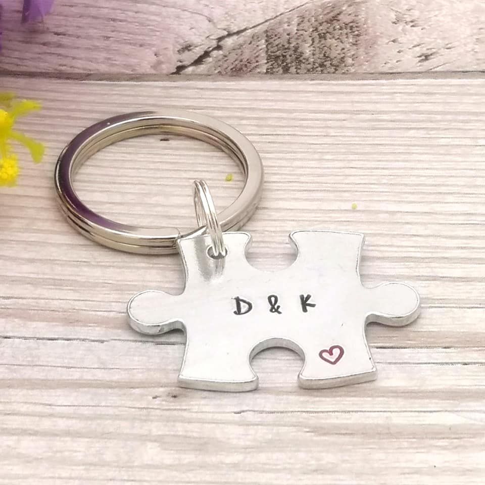 Metal jigsaw piece shaped keyring personalised with two initials