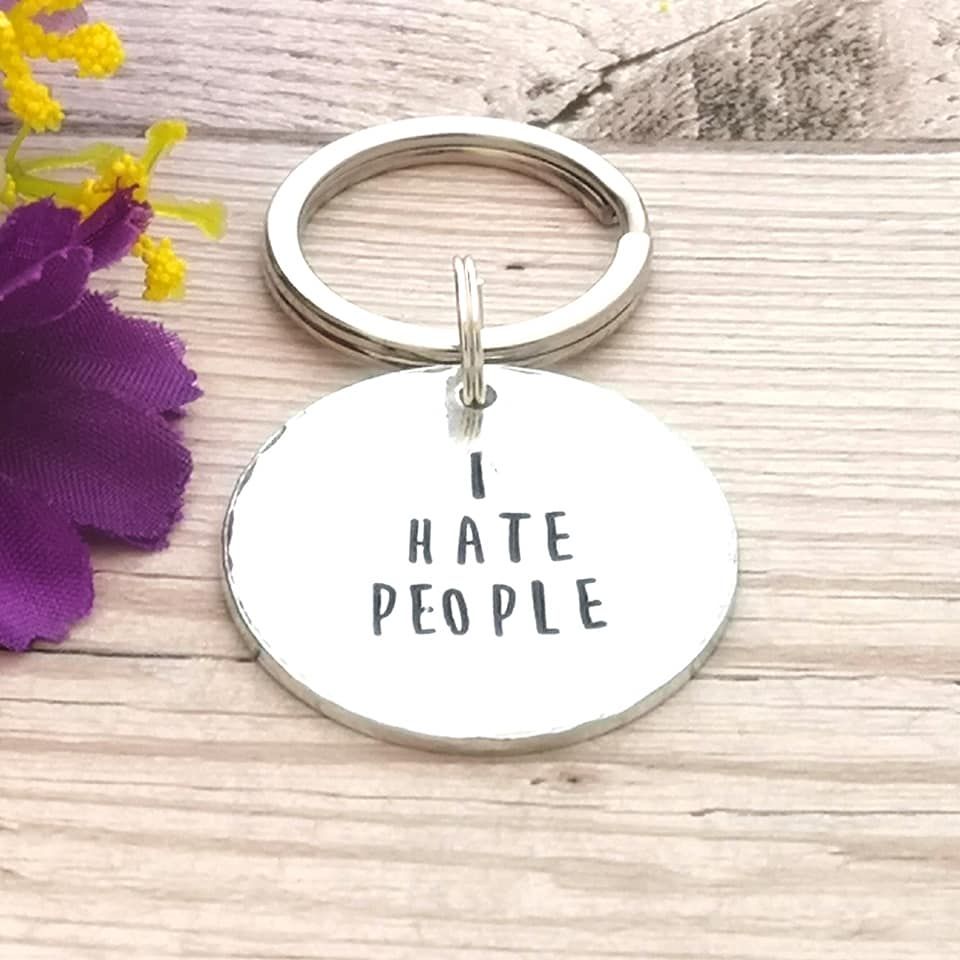 Circular metal keyring with the wording, I hate people