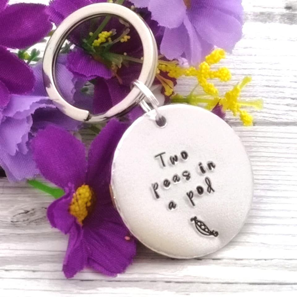 Circular metal keyring with wording, Two peas in a pod