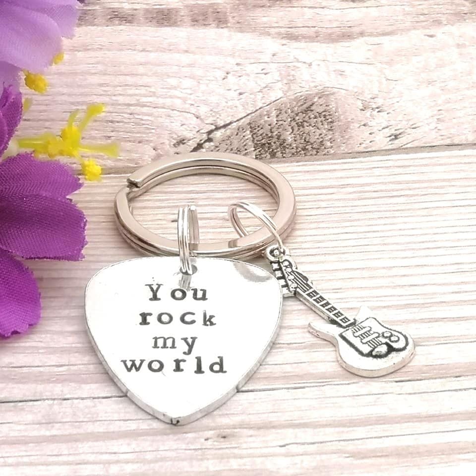 Metal guitar plectrum shaped keyring with guitar charm. You rock my world.