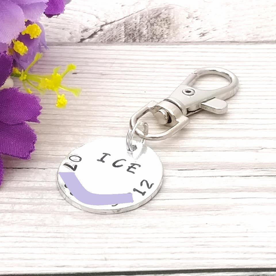 Small bag tag with phone number and wording ICE