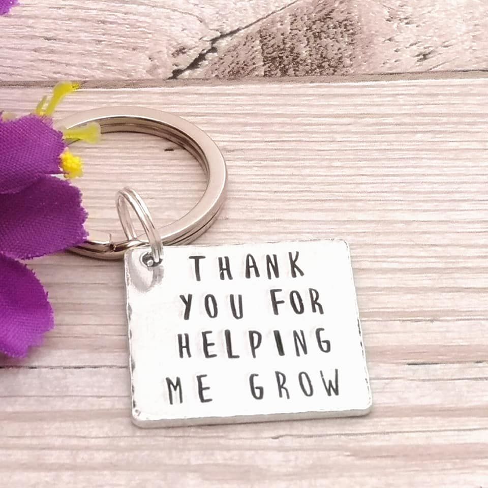 Square metal keyring with the wording Thank you for helping me grow